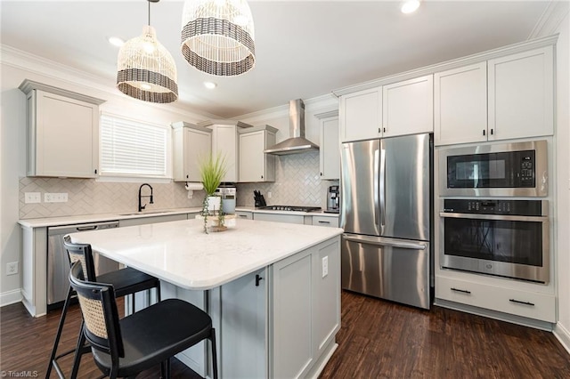 111 Park Place Cir, Winston-Salem, NC 27107 - kitchen with appliances with stainless steel finishes, wall chimney range hood, a sink, a kitchen island, and dark wood-type flooring
