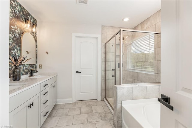 111 Park Place Cir, Winston-Salem, NC 27107 - full bath featuring a garden tub, double vanity, a stall shower, and baseboards