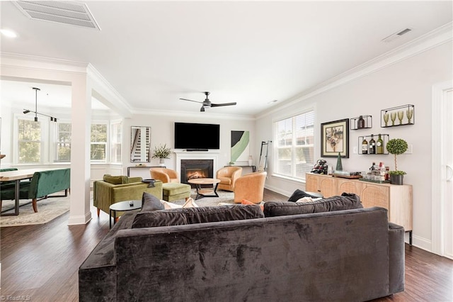 111 Park Place Cir, Winston-Salem, NC 27107 - living room with dark wood finished floors, a ceiling fan, ornamental molding, baseboards, and a warm lit fireplace