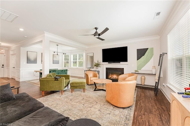 111 Park Place Cir, Winston-Salem, NC 27107 - living room featuring dark wood-style floors, a glass covered fireplace, ornamental molding, ceiling fan, and a wainscoted wall