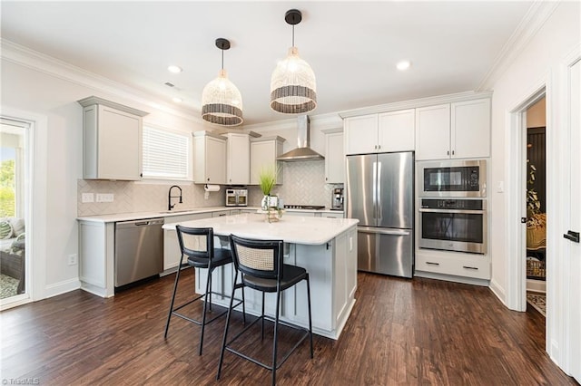 111 Park Place Cir, Winston-Salem, NC 27107 - kitchen with appliances with stainless steel finishes, wall chimney range hood, a sink, light countertops, and ornamental molding