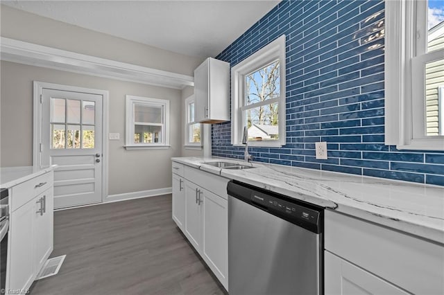 kitchen with a sink, visible vents, backsplash, dishwasher, and dark wood finished floors