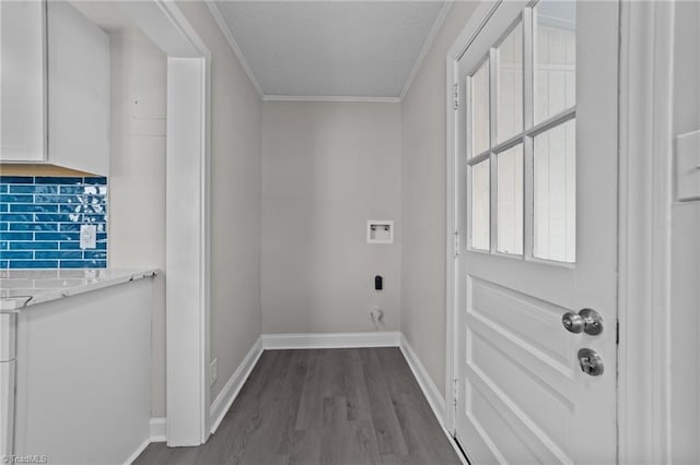 clothes washing area with laundry area, baseboards, ornamental molding, dark wood-style flooring, and a textured ceiling