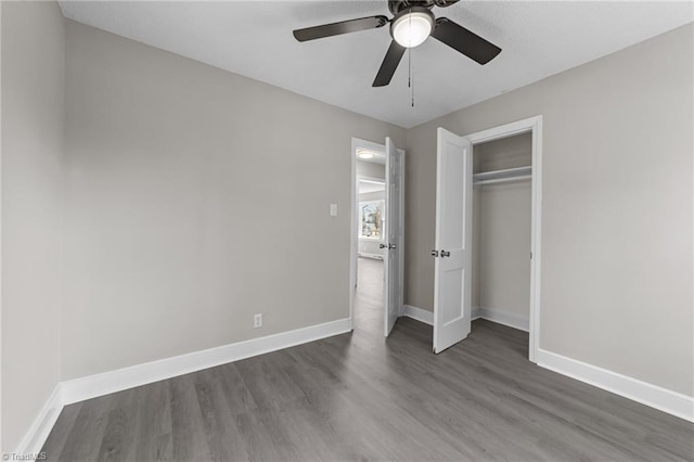 unfurnished bedroom with ceiling fan, a closet, baseboards, and wood finished floors