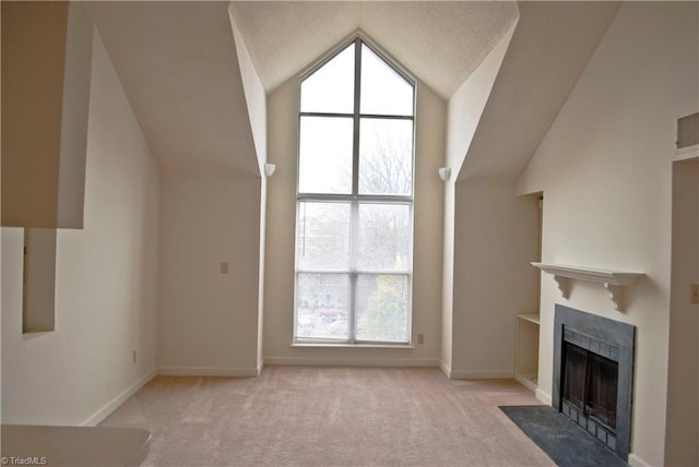 unfurnished living room with light colored carpet and high vaulted ceiling