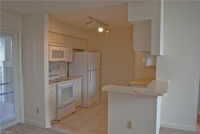 kitchen with sink, white appliances, and white cabinetry