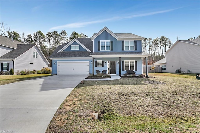 view of front facade with covered porch, concrete driveway, a front yard, and a garage