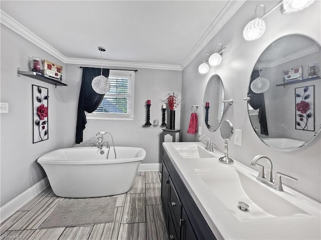 full bath with a sink, baseboards, and a freestanding tub
