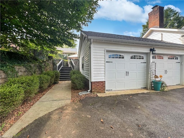 garage featuring aphalt driveway