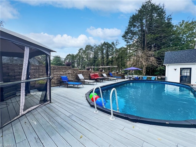 view of pool featuring a deck and a fenced in pool