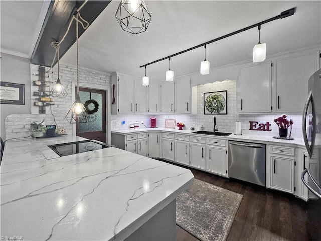 kitchen with a sink, appliances with stainless steel finishes, tasteful backsplash, and white cabinets