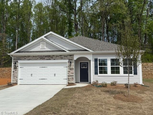 3822 Colt Ct, Trinity, NC 27370 - ranch-style house featuring concrete driveway, an attached garage, and stone siding