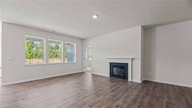 3822 Colt Ct, Trinity, NC 27370 - unfurnished living room with wood finished floors, a glass covered fireplace, baseboards, and recessed lighting