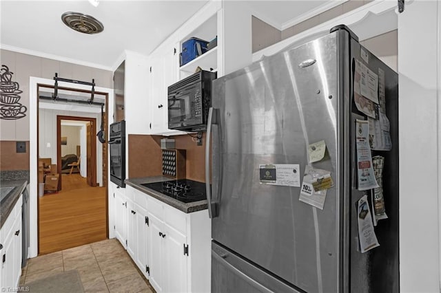365 Ransom Rd, Winston-Salem, NC 27106 - kitchen with black appliances, dark countertops, ornamental molding, white cabinets, and a barn door