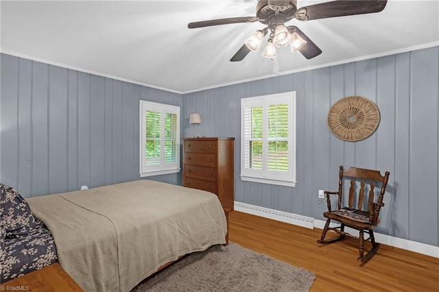 365 Ransom Rd, Winston-Salem, NC 27106 - bedroom with wood finished floors, baseboards, baseboard heating, ornamental molding, and a ceiling fan
