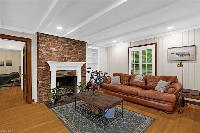 365 Ransom Rd, Winston-Salem, NC 27106 - living room with wood finished floors, beamed ceiling, a large fireplace, and built in shelves