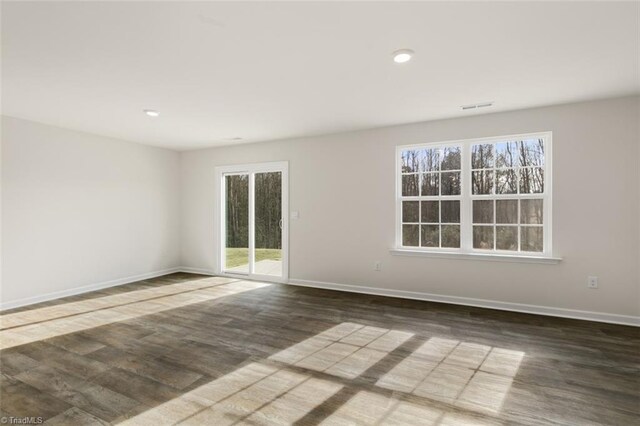 152 E Farm Loop, Stokesdale, NC 27537 - spare room featuring wood finished floors, baseboards, and a healthy amount of sunlight
