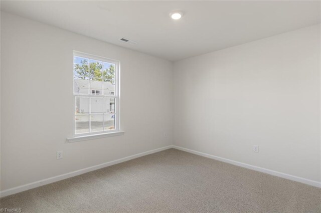 152 E Farm Loop, Stokesdale, NC 27537 - spare room featuring visible vents, baseboards, and carpet
