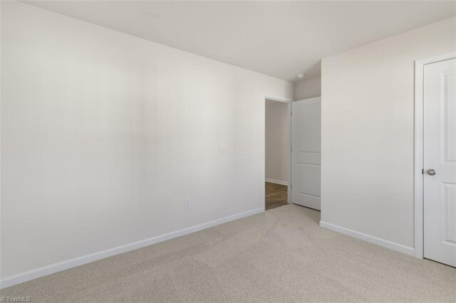 152 E Farm Loop, Stokesdale, NC 27537 - unfurnished bedroom with light carpet and baseboards
