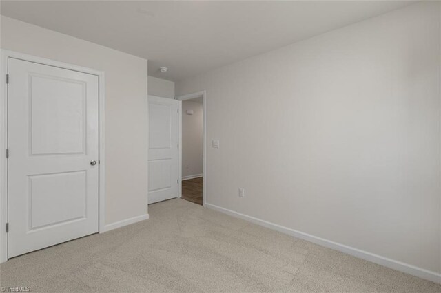 152 E Farm Loop, Stokesdale, NC 27537 - unfurnished bedroom with carpet flooring and baseboards