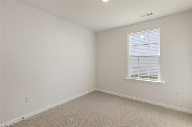 152 E Farm Loop, Stokesdale, NC 27537 - spare room featuring light colored carpet, visible vents, and baseboards
