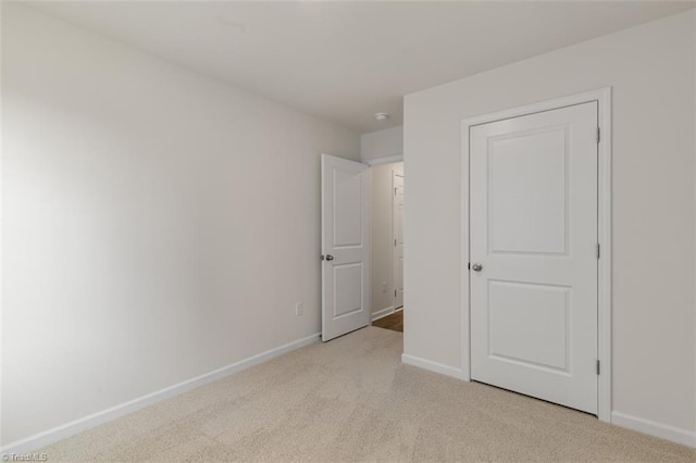 152 E Farm Loop, Stokesdale, NC 27537 - unfurnished bedroom with baseboards and light colored carpet