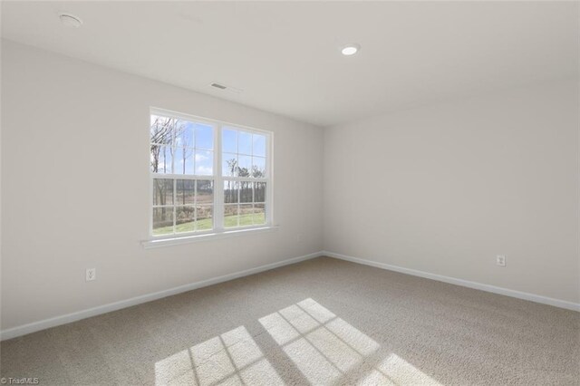 152 E Farm Loop, Stokesdale, NC 27537 - unfurnished room featuring visible vents, baseboards, and carpet floors