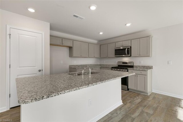 152 E Farm Loop, Stokesdale, NC 27537 - kitchen with a sink, visible vents, appliances with stainless steel finishes, and gray cabinetry