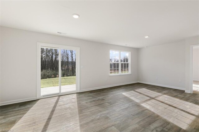152 E Farm Loop, Stokesdale, NC 27537 - spare room featuring dark wood finished floors, visible vents, recessed lighting, and baseboards