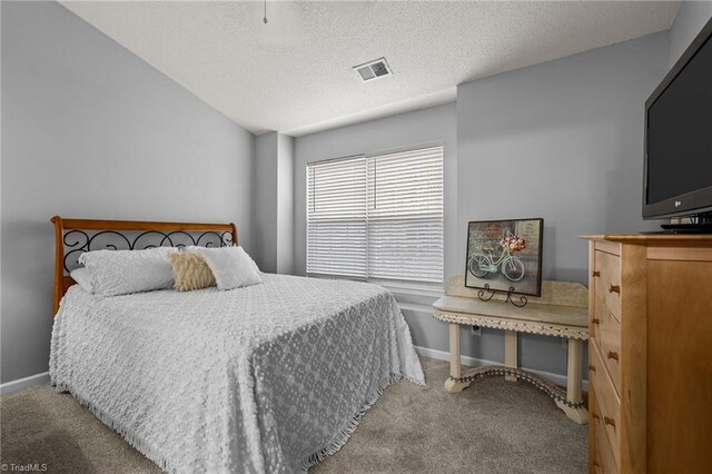 carpeted bedroom featuring a textured ceiling and vaulted ceiling