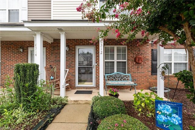 view of exterior entry featuring a porch