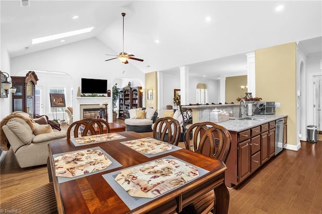 dining room with ceiling fan, ornate columns, recessed lighting, high vaulted ceiling, and dark wood-style flooring