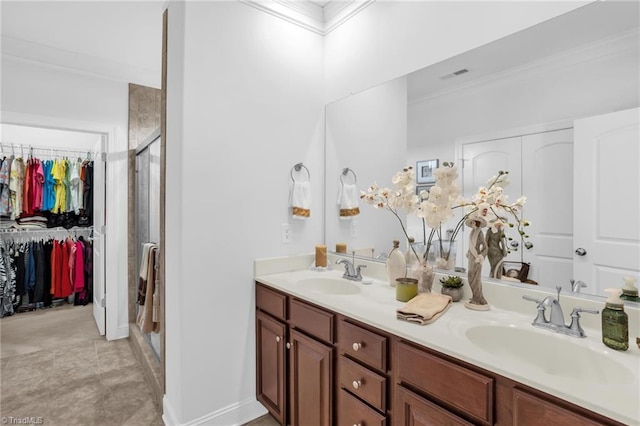 full bath with crown molding, a shower stall, double vanity, and a walk in closet