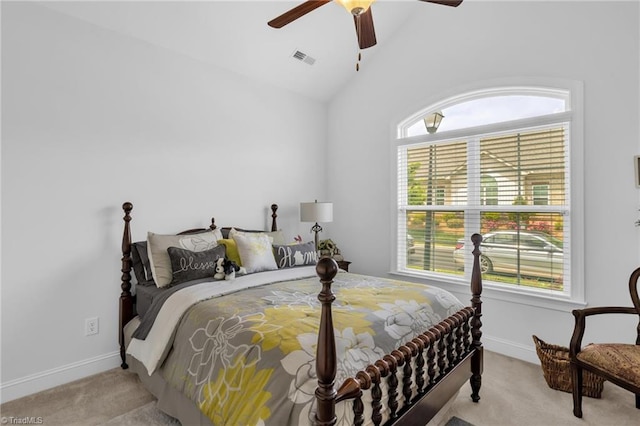 bedroom with light carpet, vaulted ceiling, baseboards, and a ceiling fan