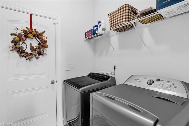 clothes washing area featuring washing machine and clothes dryer