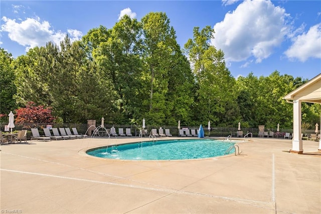 community pool featuring a patio area and fence