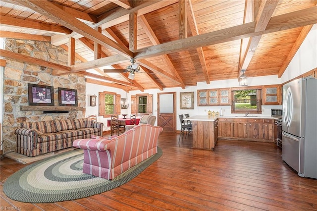 living area with dark wood-type flooring, ceiling fan, wood ceiling, and lofted ceiling with beams