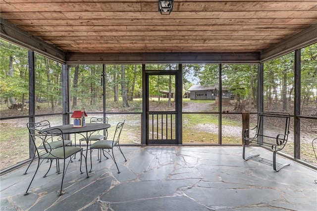 unfurnished sunroom with wooden ceiling