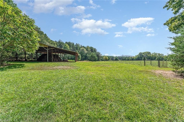view of yard with a rural view and fence