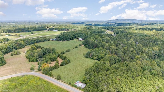 birds eye view of property with a view of trees