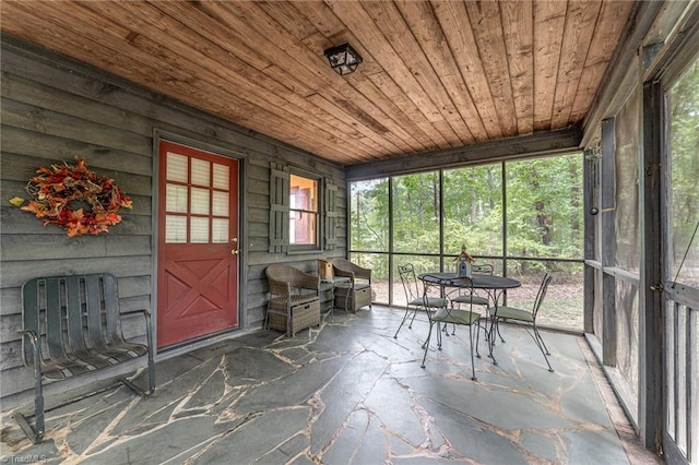 unfurnished sunroom featuring wood ceiling