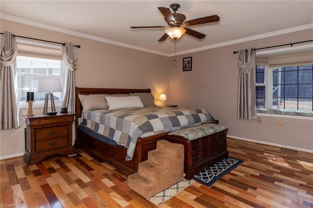 bedroom featuring crown molding, light wood-style floors, visible vents, and baseboards