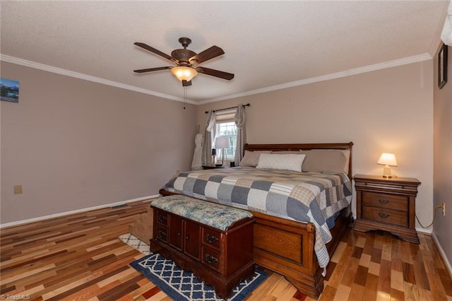 bedroom with light wood-style flooring, baseboards, ceiling fan, and crown molding