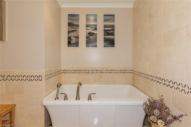 bathroom featuring a garden tub, ornamental molding, and tile walls