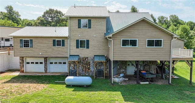 back of house with driveway, an attached garage, and a yard