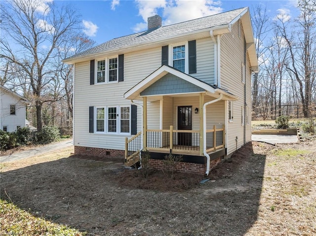 view of front facade with crawl space, covered porch, and a chimney