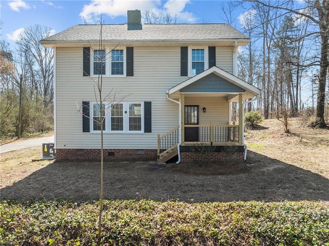 view of front of house featuring crawl space, covered porch, a chimney, and a shingled roof