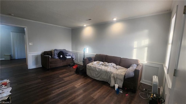 living room featuring ornamental molding, dark hardwood / wood-style floors, and a textured ceiling