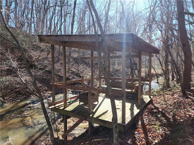 exterior space featuring a deck with water view