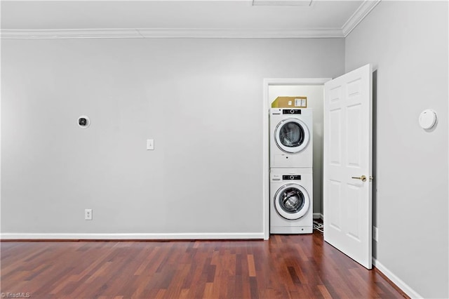 laundry area with laundry area, baseboards, stacked washing maching and dryer, dark wood-style floors, and crown molding